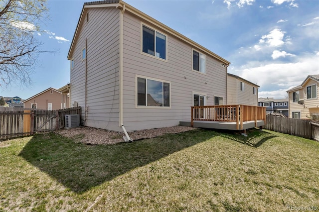 rear view of property with a fenced backyard, cooling unit, a gate, a lawn, and a deck