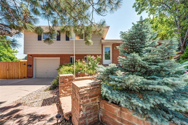 4660 E Briarwood Pl, Centennial, CO 80122 - tri-level home featuring an attached garage, driveway, and brick siding