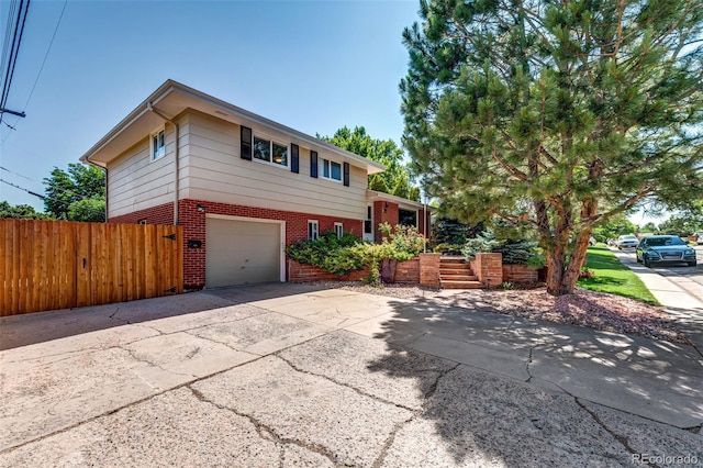 4660 E Briarwood Pl, Centennial, CO 80122 - view of front of house with brick siding, a garage, and driveway