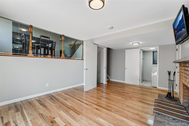 4660 E Briarwood Pl, Centennial, CO 80122 - unfurnished living room featuring wood finished floors, washer / clothes dryer, a fireplace, and stairs