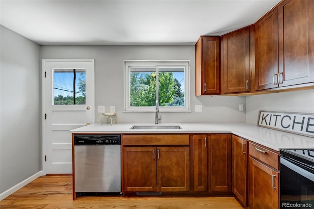 4660 E Briarwood Pl, Centennial, CO 80122 - kitchen with stainless steel dishwasher, light wood-style flooring, light countertops, and black electric range oven