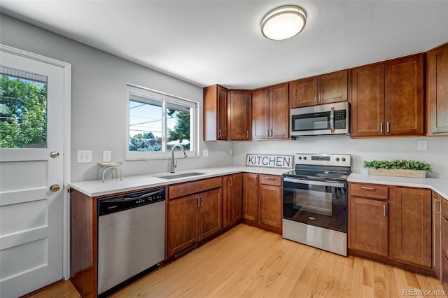 4660 E Briarwood Pl, Centennial, CO 80122 - kitchen featuring appliances with stainless steel finishes, light wood-style flooring, light countertops, and brown cabinets
