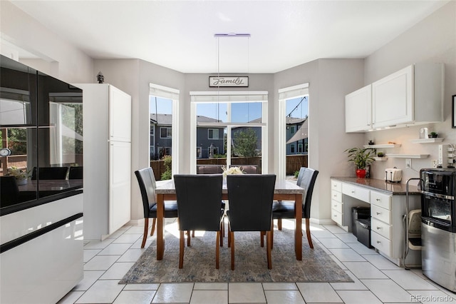 dining space featuring light tile patterned flooring