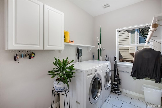 laundry area featuring cabinet space, visible vents, baseboards, independent washer and dryer, and light tile patterned flooring