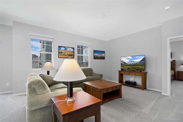 carpeted living room featuring baseboards