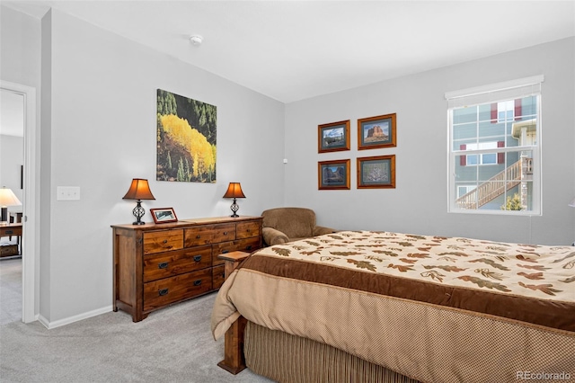 carpeted bedroom featuring baseboards