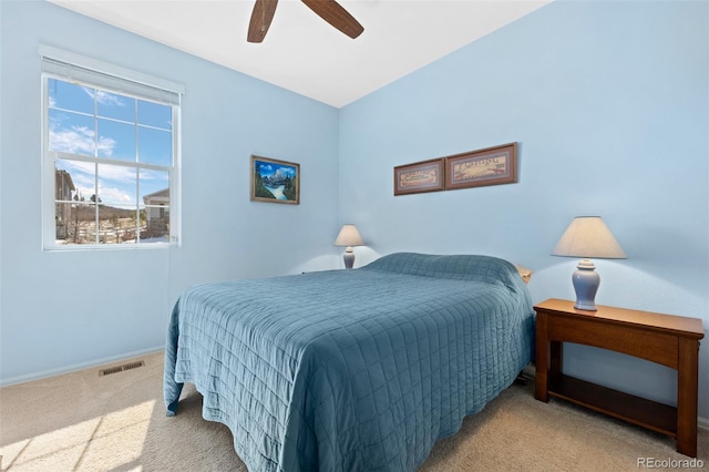 bedroom featuring visible vents, carpet floors, baseboards, and ceiling fan