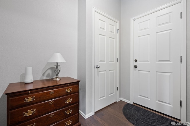 entryway featuring dark wood-style floors and baseboards