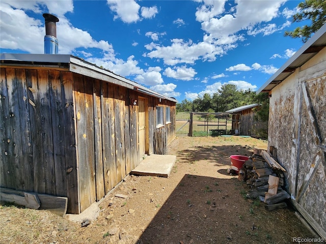 view of side of home featuring an outbuilding