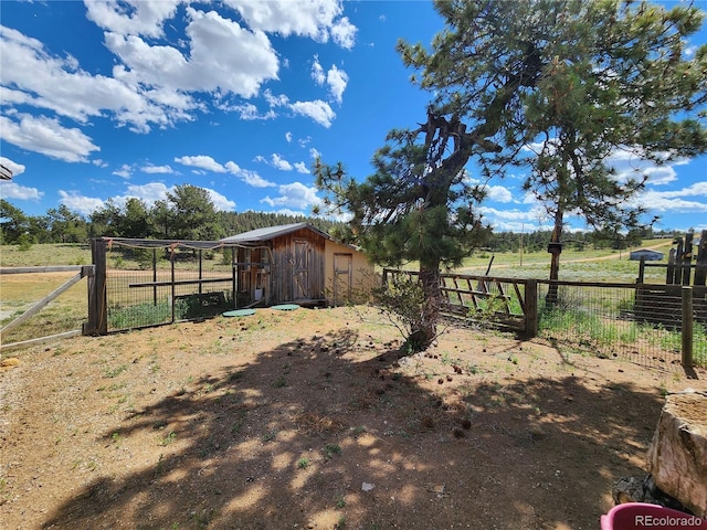 view of yard featuring a rural view and an outdoor structure