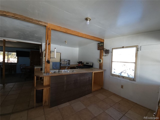 kitchen featuring stainless steel stove and tile patterned floors