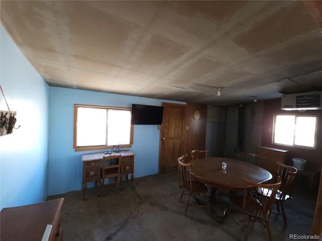 dining space featuring concrete floors