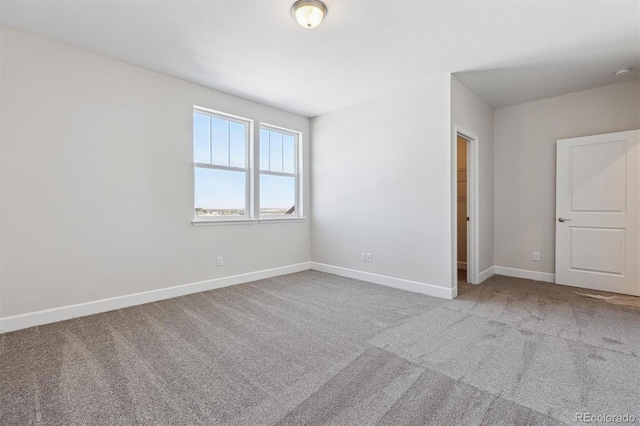 unfurnished room with light carpet