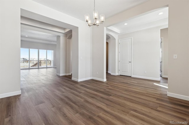 unfurnished dining area featuring an inviting chandelier and dark hardwood / wood-style floors