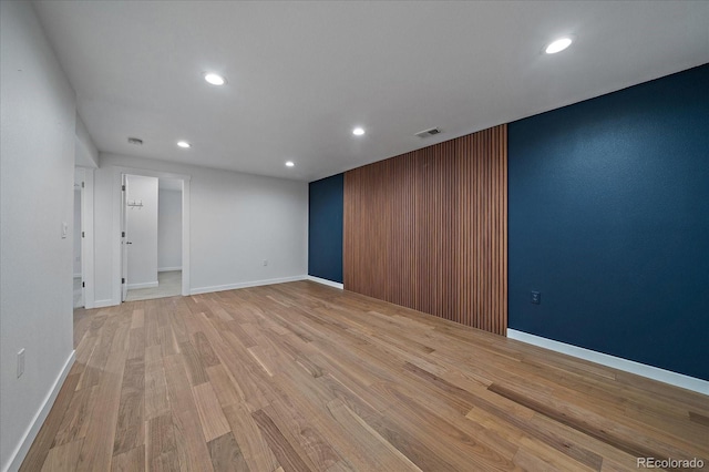 unfurnished room with light wood-style floors, baseboards, visible vents, and recessed lighting