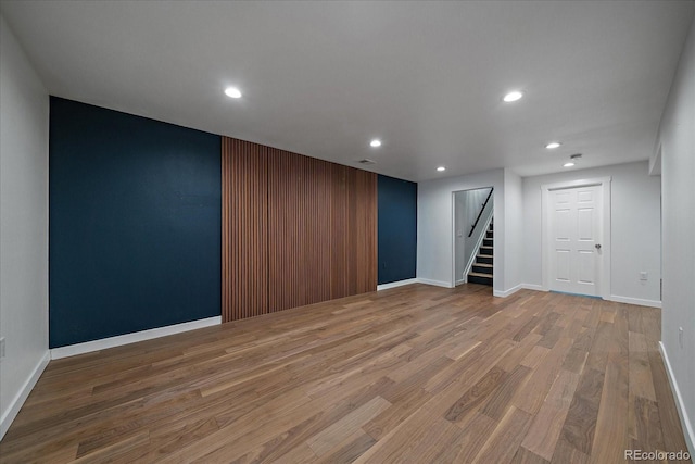 interior space featuring recessed lighting, stairs, baseboards, and wood finished floors