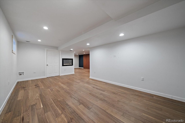 finished basement with light wood finished floors, baseboards, visible vents, and recessed lighting
