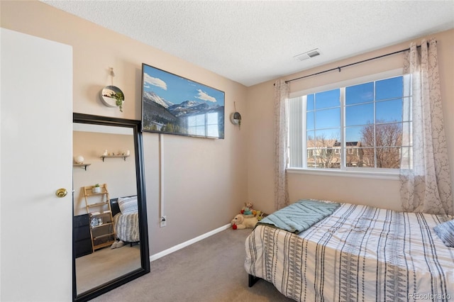 bedroom featuring carpet floors and a textured ceiling