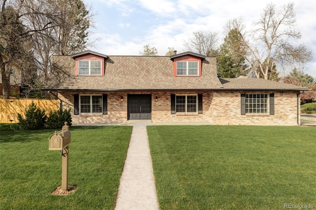 view of front of house featuring fence, a shingled roof, and a front lawn