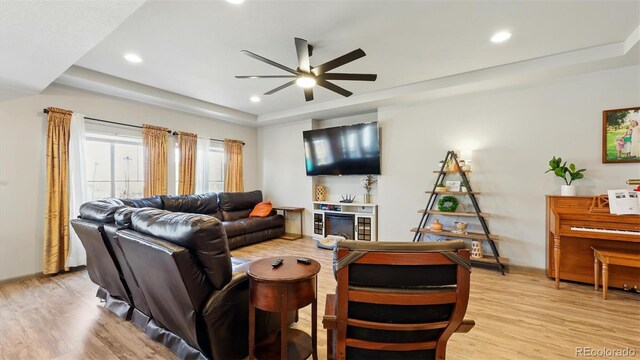 6207 Kildare Dr, Colorado Springs, CO 80927 - living room featuring a tray ceiling, ceiling fan, light wood finished floors, and recessed lighting
