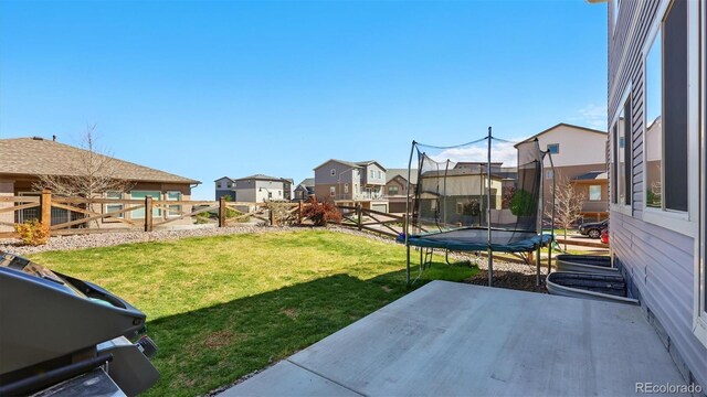 6207 Kildare Dr, Colorado Springs, CO 80927 - view of yard with a patio area, a trampoline, and a residential view