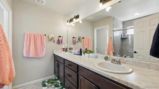 6207 Kildare Dr, Colorado Springs, CO 80927 - full bath featuring a stall shower, double vanity, baseboards, and wood finished floors
