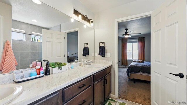 6207 Kildare Dr, Colorado Springs, CO 80927 - ensuite bathroom featuring double vanity, a stall shower, and a ceiling fan