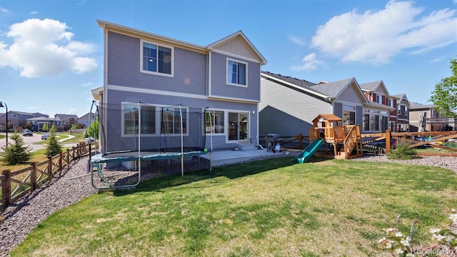 6207 Kildare Dr, Colorado Springs, CO 80927 - back of property with a trampoline, a residential view, a playground, and a patio area