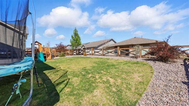 6207 Kildare Dr, Colorado Springs, CO 80927 - view of yard with a trampoline and a playground