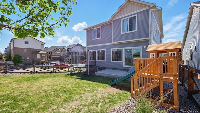 6207 Kildare Dr, Colorado Springs, CO 80927 - back of house featuring a trampoline, board and batten siding, a residential view, a playground, and a patio area