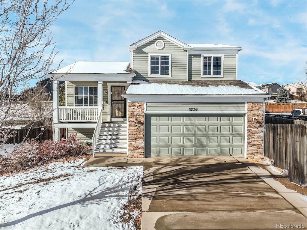 view of front of home featuring covered porch and a garage