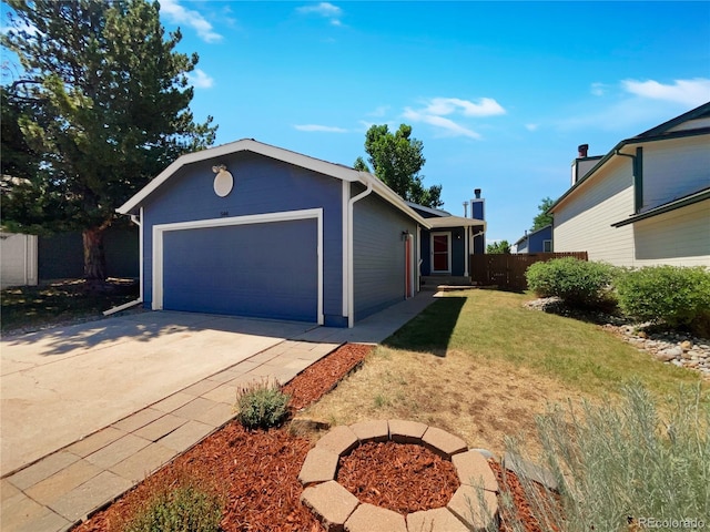 ranch-style house featuring a garage and a front lawn