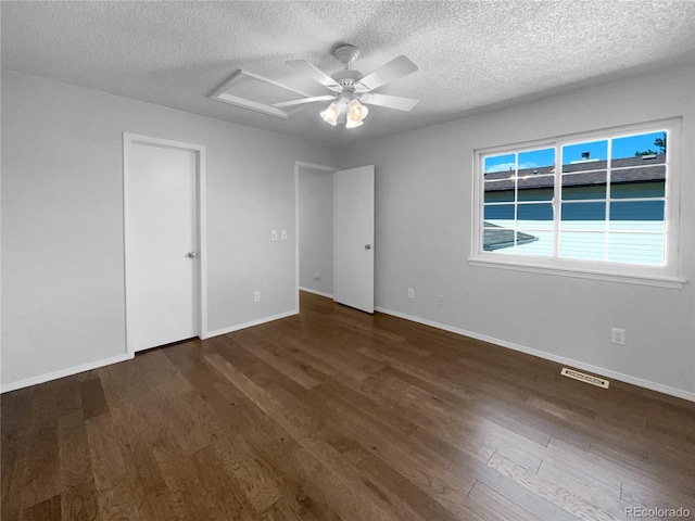 unfurnished bedroom featuring ceiling fan, dark hardwood / wood-style floors, and a textured ceiling