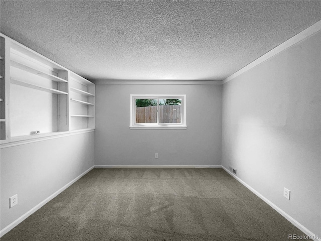 spare room featuring carpet flooring, crown molding, and a textured ceiling