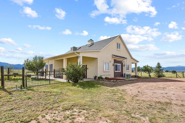 exterior space with a mountain view, a rural view, and a lawn