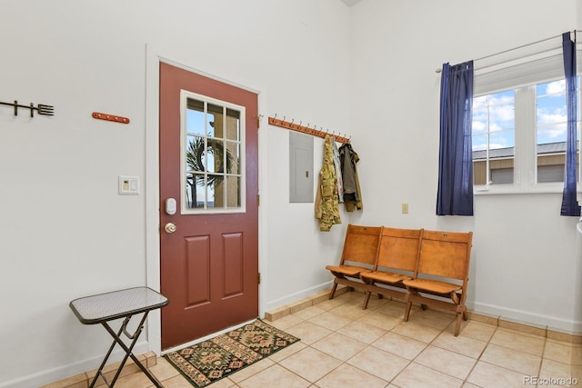 entrance foyer featuring electric panel, plenty of natural light, and light tile patterned floors