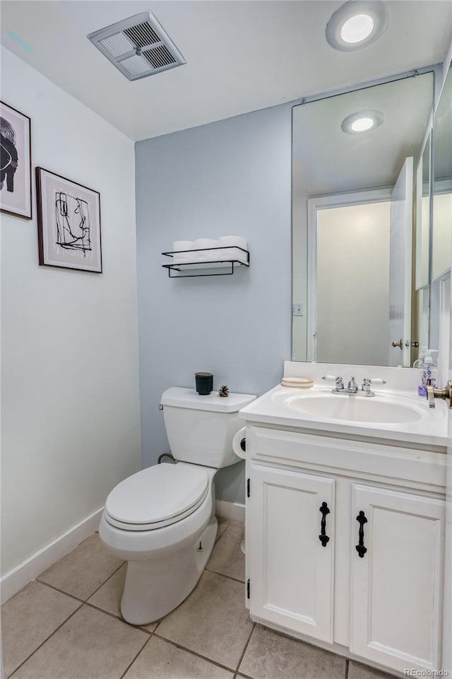 half bathroom featuring toilet, vanity, baseboards, visible vents, and tile patterned floors