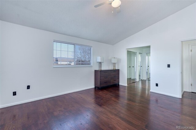 unfurnished bedroom with a ceiling fan, lofted ceiling, baseboards, and wood finished floors