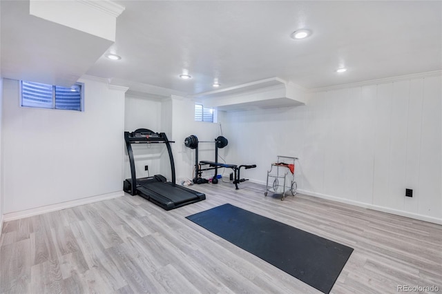 exercise area with baseboards, ornamental molding, wood finished floors, and recessed lighting