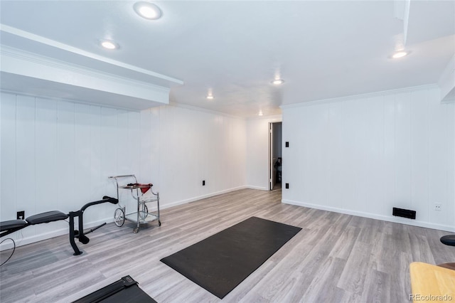 workout area featuring baseboards, ornamental molding, wood finished floors, and recessed lighting