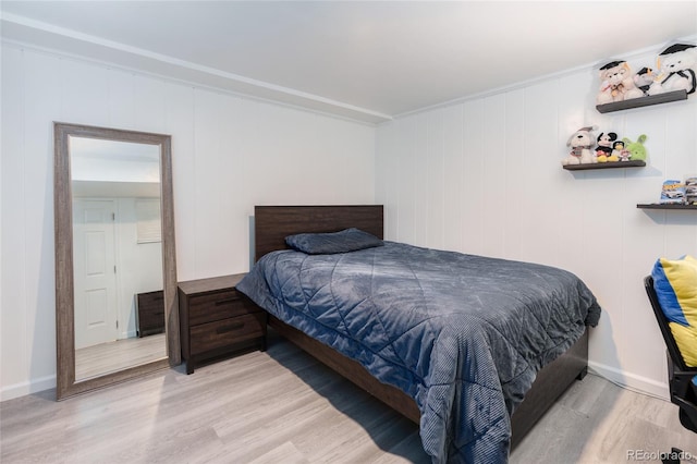 bedroom with light wood-style flooring and baseboards