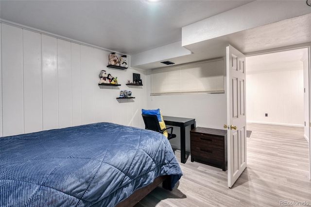 bedroom with visible vents and light wood-style flooring