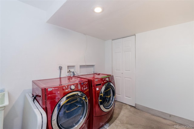 laundry area with laundry area, baseboards, and separate washer and dryer