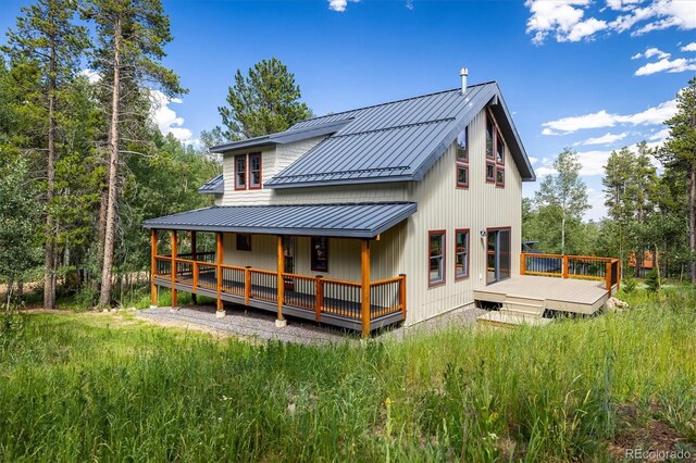 713 Rudi Ln, Golden, CO 80403 - rear view of property featuring a metal roof, a standing seam roof, and covered porch