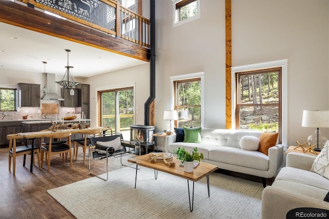 713 Rudi Ln, Golden, CO 80403 - living area featuring a towering ceiling, dark wood-style floors, and a wood stove