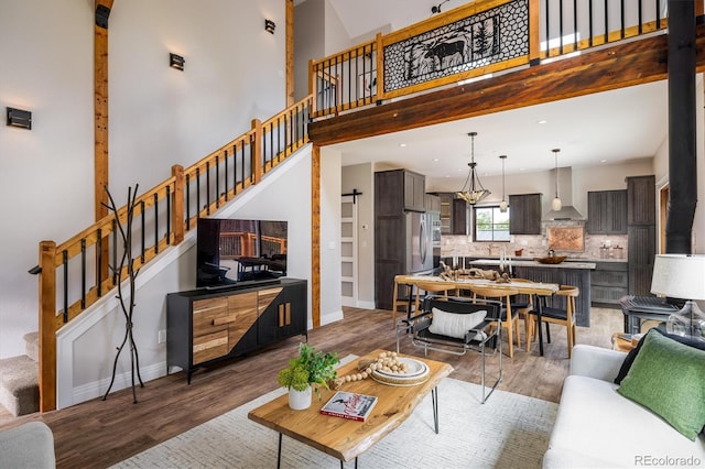 713 Rudi Ln, Golden, CO 80403 - living room with stairway, light wood-style floors, a towering ceiling, and recessed lighting