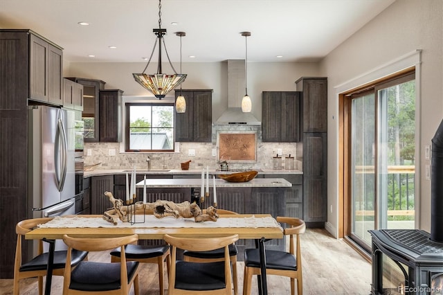713 Rudi Ln, Golden, CO 80403 - kitchen with wall chimney exhaust hood, dark brown cabinetry, tasteful backsplash, and recessed lighting