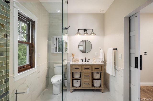 713 Rudi Ln, Golden, CO 80403 - bathroom featuring vanity, marble finish flooring, and a wainscoted wall