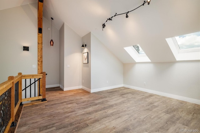 713 Rudi Ln, Golden, CO 80403 - additional living space featuring a skylight, vaulted ceiling, and wood finished floors