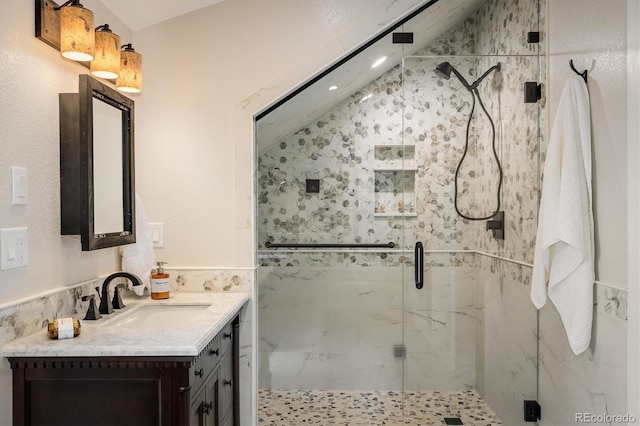 713 Rudi Ln, Golden, CO 80403 - bathroom with tile walls, vanity, a marble finish shower, and a wainscoted wall